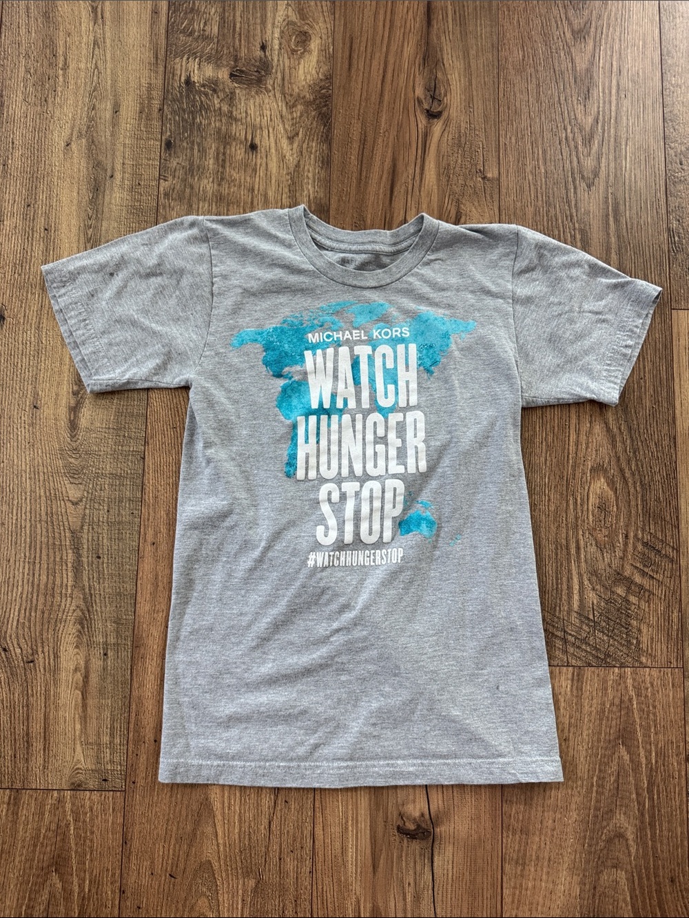 Michael Kors Limited Edition Gray Tee with Blue Graphic "Watch Hunger Stop"